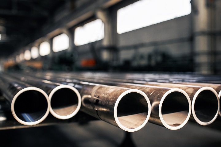 Metallic pipes on warehouse, rows of metal pipes on industrial warehouse. Industrial interior,
