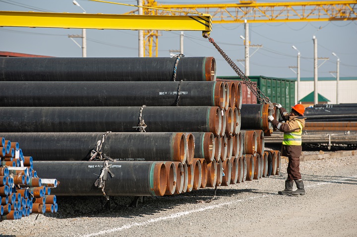Line of oilfield large streel pipes in industrial construction area
